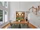 Dining area with high ceilings, modern lighting, hardwood floors and built-in shelving at 201 Red Bud Ln, Chapel Hill, NC 27514