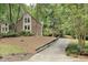 Brick home with a well-maintained lawn and a long driveway surrounded by trees at 201 Red Bud Ln, Chapel Hill, NC 27514