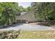 Two car garage with extended driveway on a home surrounded by green trees at 201 Red Bud Ln, Chapel Hill, NC 27514