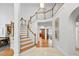Open foyer with hardwood staircase, tile flooring, and views into adjacent living spaces at 201 Red Bud Ln, Chapel Hill, NC 27514