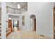Spacious foyer with tile floor, white trim, arched doorway, and staircase with white railing at 201 Red Bud Ln, Chapel Hill, NC 27514