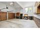 Spacious garage with storage cabinets, work bench, brick accents, and ample room for vehicles at 201 Red Bud Ln, Chapel Hill, NC 27514