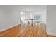 Hallway with hardwood floors, white walls, and views of the living area through white railings at 201 Red Bud Ln, Chapel Hill, NC 27514