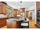 Kitchen with island, granite countertops, stainless appliances, and wood cabinets at 201 Red Bud Ln, Chapel Hill, NC 27514