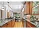 Well-lit kitchen with wood cabinets, granite counters, tile backsplash, and eating nook at 201 Red Bud Ln, Chapel Hill, NC 27514