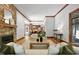 The home's open concept features wood floors, a fireplace, living room, dining, and kitchen areas at 201 Red Bud Ln, Chapel Hill, NC 27514