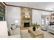 This living room features a beautiful stone fireplace, wood trim, and seamlessly connects to the dining area at 201 Red Bud Ln, Chapel Hill, NC 27514