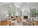 Bright living room with vaulted ceilings, large windows, fireplace, and stylish furniture at 201 Red Bud Ln, Chapel Hill, NC 27514