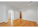 Open living room boasts hardwood floors, arched doorways, and detailed trim, with neutral paint at 201 Red Bud Ln, Chapel Hill, NC 27514