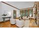 Bright living room with a stone fireplace and large windows offering natural light and outdoor views at 201 Red Bud Ln, Chapel Hill, NC 27514