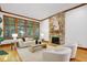 Inviting living room with stone fireplace, hardwood floors and ample natural light at 201 Red Bud Ln, Chapel Hill, NC 27514