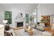 Well-lit living room with fireplace, hardwood floors, neutral furniture, and view to dining at 201 Red Bud Ln, Chapel Hill, NC 27514
