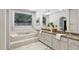 Spacious bathroom features marble-surround tub, granite counters, and dual sinks at 201 Red Bud Ln, Chapel Hill, NC 27514