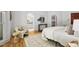 Bright main bedroom featuring hardwood floors, arched doorways, and elegant decor at 201 Red Bud Ln, Chapel Hill, NC 27514