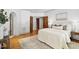 Spacious main bedroom showcasing hardwood flooring, neutral decor and multiple doorways at 201 Red Bud Ln, Chapel Hill, NC 27514