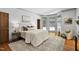Bright main bedroom boasts hardwood floors, area rug, bay window, and comfortable furnishings at 201 Red Bud Ln, Chapel Hill, NC 27514