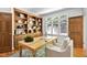 Bright office with large window, custom built-in shelves, and a comfortable area rug at 201 Red Bud Ln, Chapel Hill, NC 27514