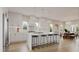 Spacious, modern kitchen with white cabinets, marble countertops, and seating for six at 203 E Winmore Ave, Chapel Hill, NC 27516