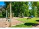 Community playground area with swings, slides, and a soft surface for safety at 203 E Winmore Ave, Chapel Hill, NC 27516