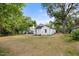 A spacious backyard on a sunny day, surrounded by lush trees at 208 W Holt St, Burlington, NC 27217