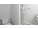 Modern bathroom featuring a toilet and a shower with glass doors at 208 W Holt St, Burlington, NC 27217