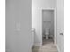 The bathroom has a single sink, a toilet, and a doorway to the bath/shower at 208 W Holt St, Burlington, NC 27217