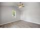 Bright bedroom features a modern ceiling fan, neutral paint, luxury vinyl flooring, and a window for ample natural light at 208 W Holt St, Burlington, NC 27217