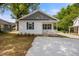 A charming home featuring a welcoming porch with a new concrete driveway at 208 W Holt St, Burlington, NC 27217