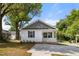 Charming single-story home featuring a welcoming porch and a new driveway at 208 W Holt St, Burlington, NC 27217