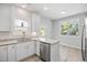Bright kitchen features modern stainless steel appliances, granite countertops, and white cabinets at 208 W Holt St, Burlington, NC 27217