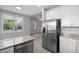 Modern kitchen featuring stainless steel refrigerator and granite countertops at 208 W Holt St, Burlington, NC 27217