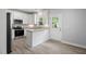 Bright kitchen features modern stainless steel appliances, granite countertops, and white cabinets at 208 W Holt St, Burlington, NC 27217