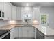 Bright kitchen features modern stainless steel appliances, granite countertops, and white cabinets at 208 W Holt St, Burlington, NC 27217