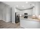 Bright kitchen featuring an open layout, white cabinets, and stainless steel appliances at 208 W Holt St, Burlington, NC 27217