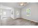 Bright living room featuring luxury vinyl flooring, neutral paint, and two windows for ample natural light at 208 W Holt St, Burlington, NC 27217