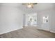 Open-concept living room featuring luxury vinyl flooring, neutral paint, and views to the kitchen at 208 W Holt St, Burlington, NC 27217