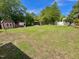 Expansive backyard featuring a gazebo and storage sheds surrounded by lush greenery and mature trees at 213 N Brevard St, Selma, NC 27576