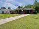 Brick home with a long driveway and manicured lawn at 213 N Brevard St, Selma, NC 27576