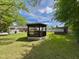 Backyard view of wooden gazebo, shed, and home exterior showcasing the outdoor space at 213 N Brevard St, Selma, NC 27576