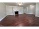 Spacious living room with hardwood floors and classic fireplace at 213 N Brevard St, Selma, NC 27576