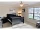 Bright bedroom featuring a ceiling fan, neutral walls, and a large window at 2193 Boyd Creek Dr, Graham, NC 27253