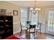 Bright dining area with modern chandelier and windows overlooking outdoor scenery at 2193 Boyd Creek Dr, Graham, NC 27253