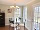 Bright dining area with modern chandelier and windows overlooking outdoor scenery at 2193 Boyd Creek Dr, Graham, NC 27253