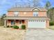 Charming two-story brick home with a well-manicured lawn and attached two-car garage at 2193 Boyd Creek Dr, Graham, NC 27253