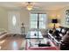 Well-lit living room with hardwood flooring, neutral colors, and modern decor accents at 2193 Boyd Creek Dr, Graham, NC 27253