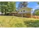 Back exterior view of the home featuring a brick facade, deck, and grassy yard at 2300 Radius Cir, Sanford, NC 27330