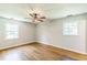 Bedroom with hardwood floors, a ceiling fan, and natural light from two windows at 2300 Radius Cir, Sanford, NC 27330