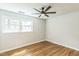 Bedroom features hardwood floors, a ceiling fan, and natural light from two windows at 2300 Radius Cir, Sanford, NC 27330