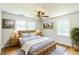 Bright bedroom featuring a wooden bed frame, two windows, and a ceiling fan at 2300 Radius Cir, Sanford, NC 27330