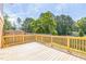 Wood deck showcasing an outdoor space bordered by a wooden fence and lush green trees at 2300 Radius Cir, Sanford, NC 27330